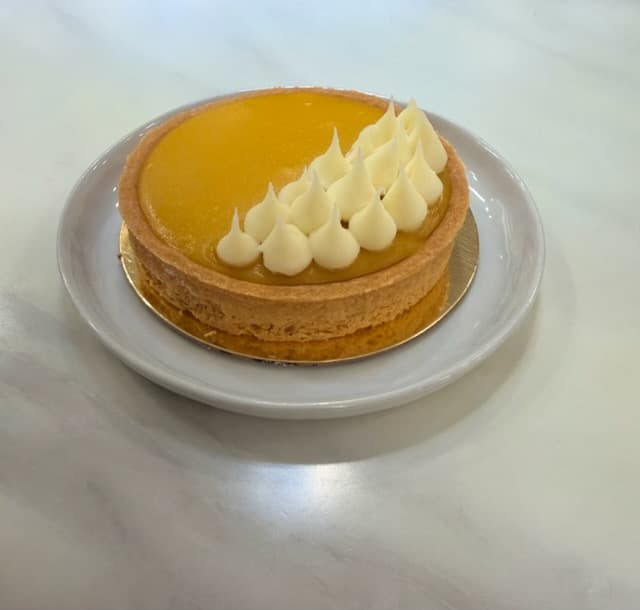 Passion fruit tart with piped cream