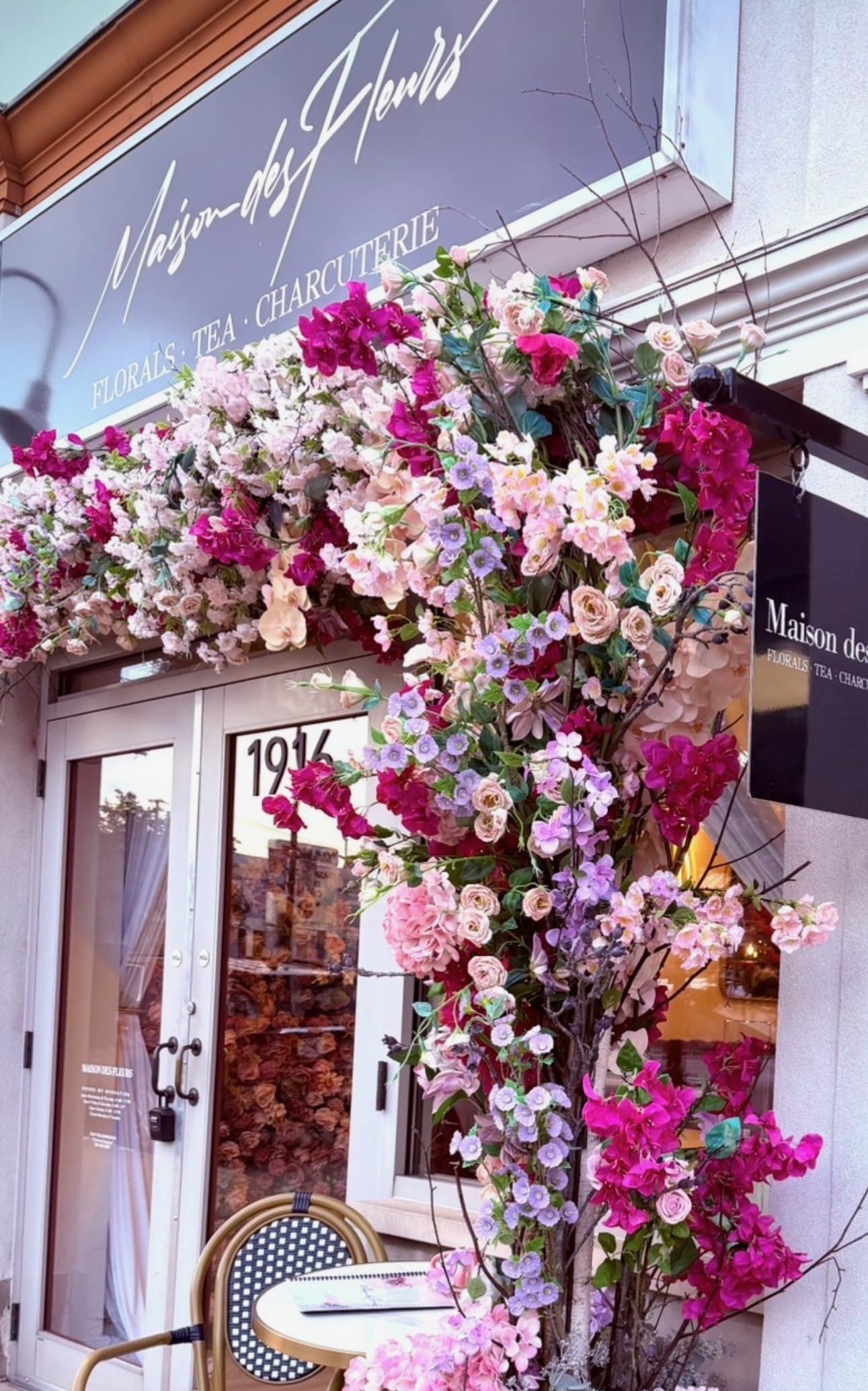 The Maison des Fleurs storefront framed with cascading florals