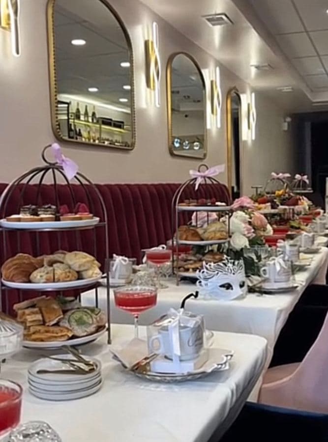 An elegant Afternoon Tea table set with birdcage tiers, florals, and coupes