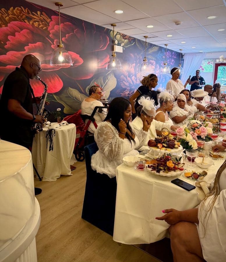 Guests enjoying Afternoon Tea while the saxophonist plays