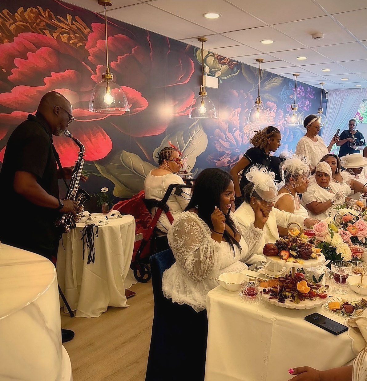 Guests gathered for tea at The Parlour with live saxophone