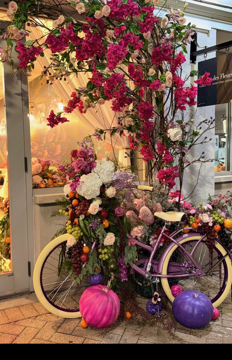 The Parlour storefront with bougainvillea and a lavender bicycle